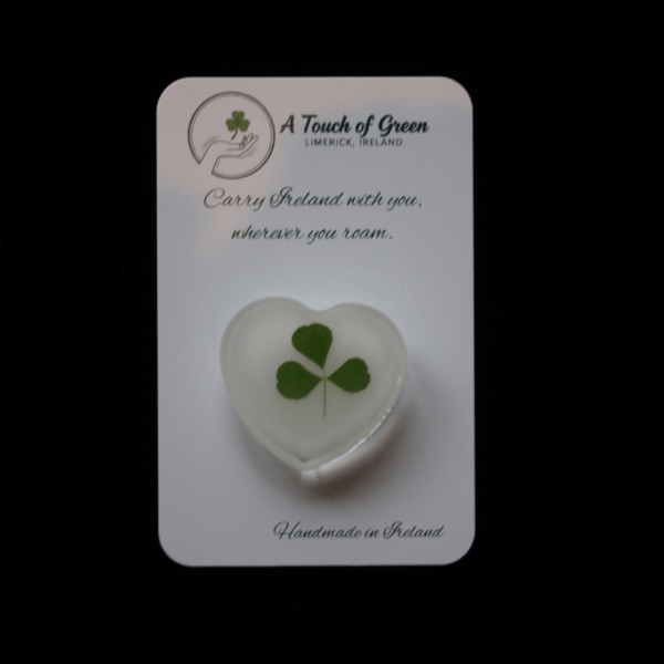 Hand foraged shamrock on a card with black background