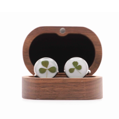 Cufflinks with hand foraged shamrock design in a wooden box on a white background
